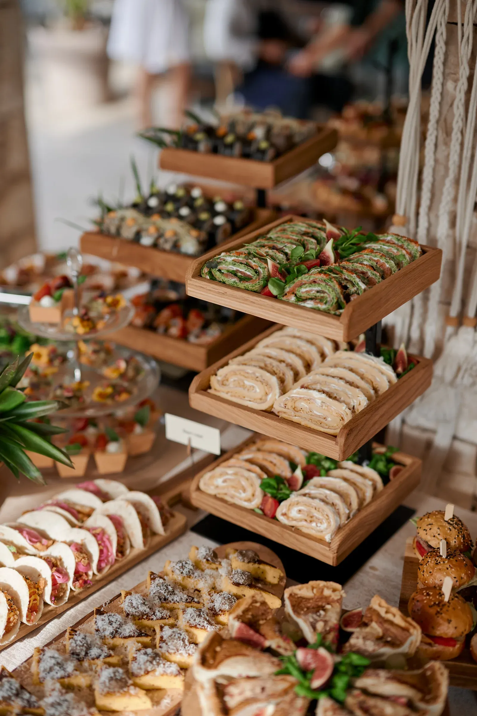 Tiered display of wraps, sushi and sandwiches
