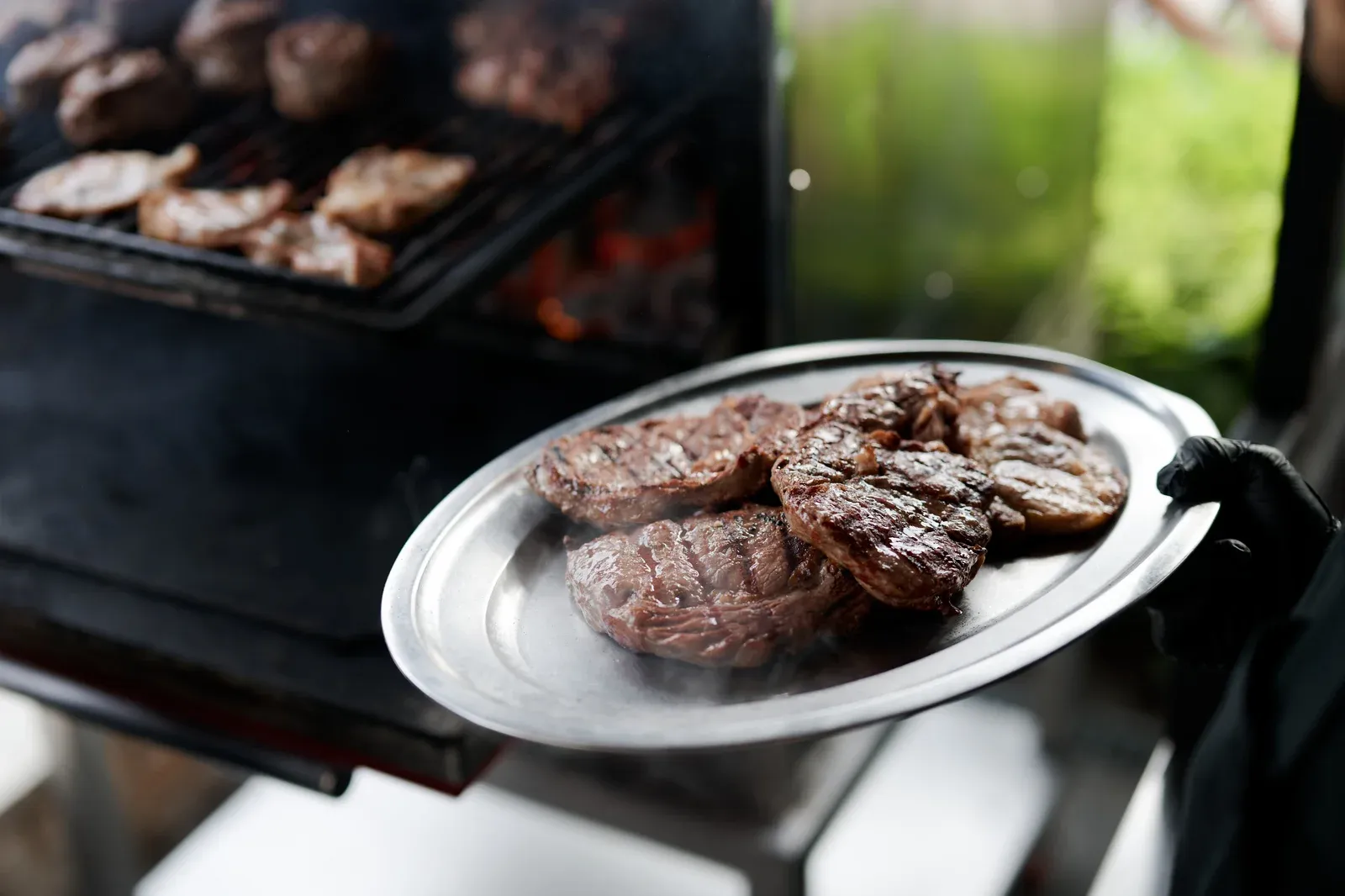 Catering team serving mini burgers on terrace