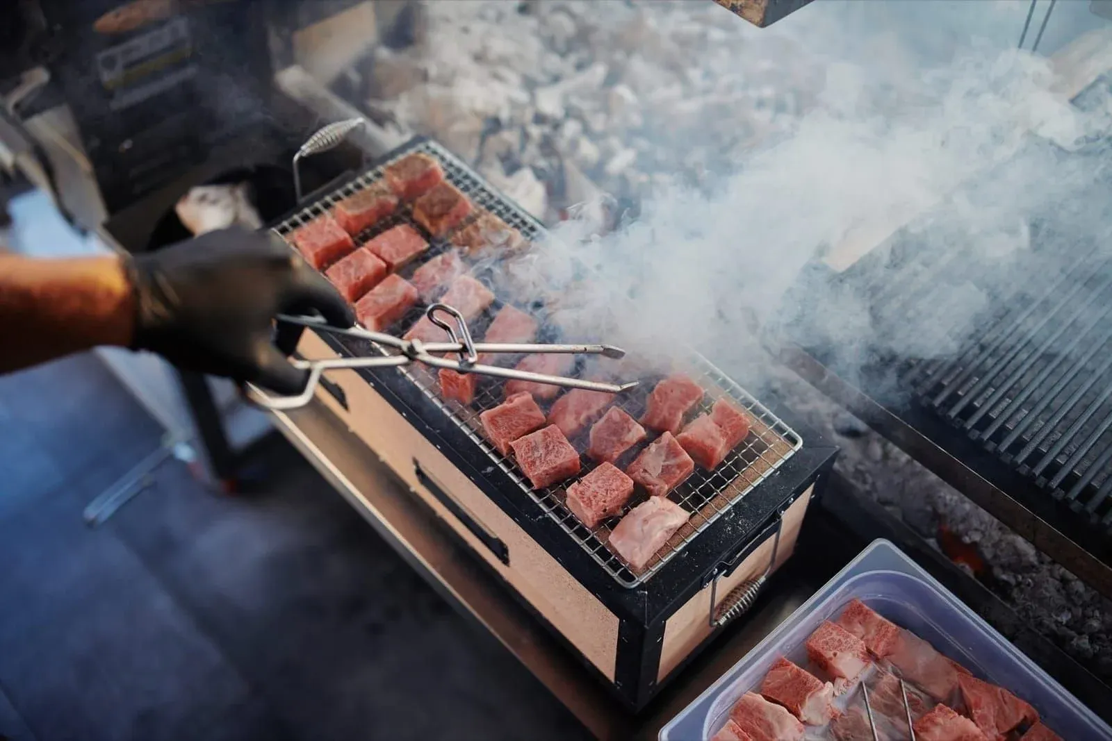 Steaks on open flame charcoal grill